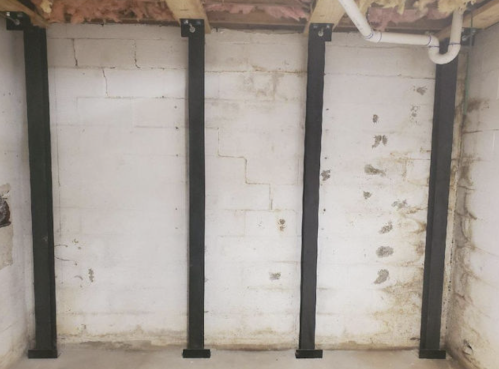 foundational repair Force Beam Support System to stabilize a basement wall on a home in Western North Carolina of North Carolina.